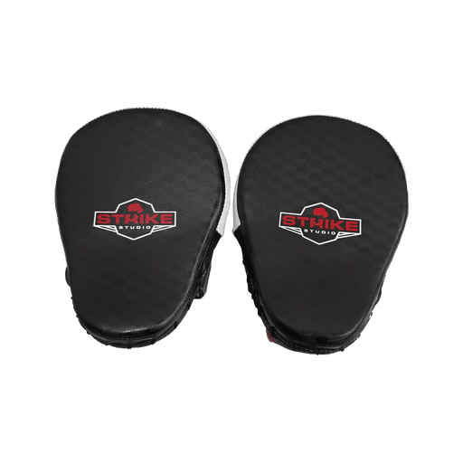 A pair of black martial arts focus mitts with a textured surface, featuring a red and white 'Strike Studio' logo on each side, set against a plain white background.
